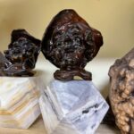 carved apple sculptures - on marble multi faceted base (2.5”) total 5.5” folk art statis SCULPTOR ISADORE `SHEP' SHAPIRO, 79 Kenan Heise, Tribune Staff Writer CHICAGO TRIBUNE Sculptor Isadore "Shep" Shapiro, 79, carved faces in apples, used a process that preserved them and then marketed his creations throughout the country. Mr. Shapiro used "Shep" as his first name. A resident of Highland Park, he died Wednesday in Brentwood North Nursing & Rehabilitation Center, Riverwoods. Making faces and dolls from apples is a tradition, he told the Tribune in a 1965 interview, that goes back to the Seneca Indians and residents of southern Appalachia. "He developed it on a very sophisticated level," his wife, Rona, who worked with him, said. "It all started accidentally when he was visiting his mother in the hospital. He carved a face in an apple and it was very good. He subsequently perfected a technique using an epoxy resin coating that has continued to preserve many of them for more than 25 years." The faces he made were sold through Marshall Field & Co., C.D. Peacock & Co. and Alfred Dunhill as well as outlets in Amsterdam and Milan, Italy, she said. Survivors, besides his wife, include two daughters, Holly-Dale Shapiro and Letty Ann Shapiro; a sister; and a granddaughter. Graveside services will be held at 11 a.m. Friday at Westlawn Cemetery, 7801 W. Montrose Ave., Norridge.