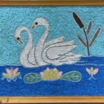 outsider art rock assemblage on plywood of two swans on lake with cattail 14.5 x 19.5