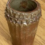 pottery vase with three rows of scalloped edges green over brown glaze / heavy clay Signed Cody Widmeier and another signature row illegible and word art. Bought in Dubuque, IA so could be Cody Widmeier from Widmeier Flooring & Furnature 8”
