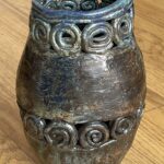 pottery vase with two rings of coiled circles and a raklu lioke glaze. 8.5” tall. signed Elizabeth B (biscotti??)