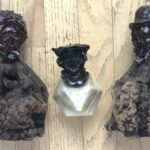 3 apple sculptures - one on onyx multi faceted base (2.5”) total 5” two others on driftewood folk art statis SCULPTOR ISADORE `SHEP' SHAPIRO, 79 Kenan Heise, Tribune Staff Writer CHICAGO TRIBUNE Sculptor Isadore "Shep" Shapiro, 79, carved faces in apples, used a process that preserved them and then marketed his creations throughout the country. Mr. Shapiro used "Shep" as his first name. A resident of Highland Park, he died Wednesday in Brentwood North Nursing & Rehabilitation Center, Riverwoods. Making faces and dolls from apples is a tradition, he told the Tribune in a 1965 interview, that goes back to the Seneca Indians and residents of southern Appalachia. "He developed it on a very sophisticated level," his wife, Rona, who worked with him, said. "It all started accidentally when he was visiting his mother in the hospital. He carved a face in an apple and it was very good. He subsequently perfected a technique using an epoxy resin coating that has continued to preserve many of them for more than 25 years." The faces he made were sold through Marshall Field & Co., C.D. Peacock & Co. and Alfred Dunhill as well as outlets in Amsterdam and Milan, Italy, she said. Survivors, besides his wife, include two daughters, Holly-Dale Shapiro and Letty Ann Shapiro; a sister; and a granddaughter. Graveside services will be held at 11 a.m. Friday at Westlawn Cemetery, 7801 W. Montrose Ave., Norridge.